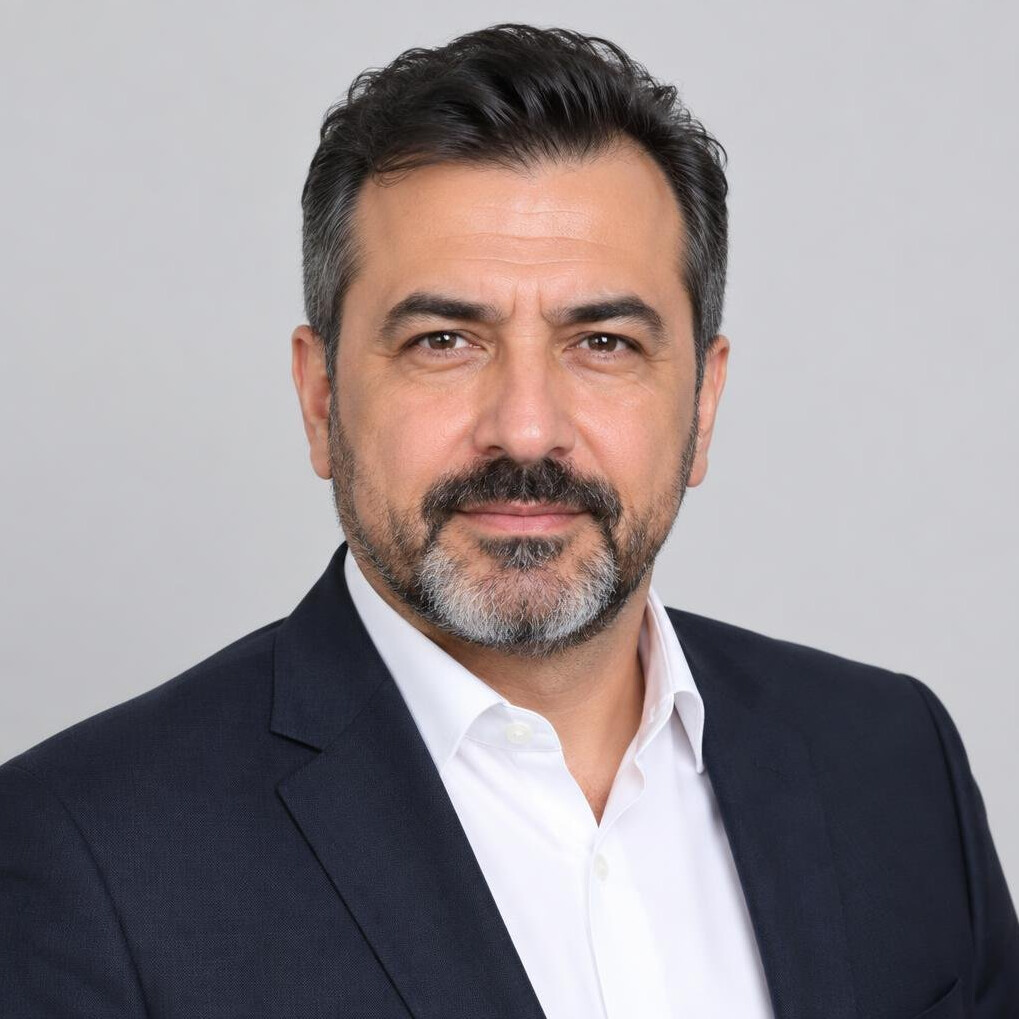 Turkish man crisis communication coach in a professional headshot